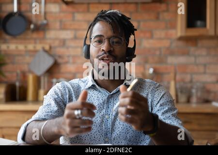 Screen view happy young african man holding video call conversation. Stock Photo