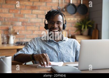 Happy young african american man in headset laughing. Stock Photo