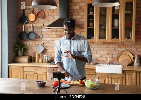 Happy young african american food blogger recording video. Stock Photo