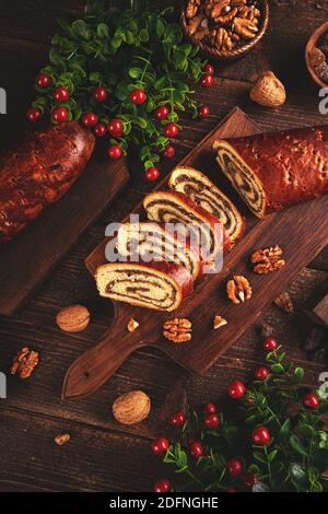 Beigli, slices of Hungarian walnut roll on wooden cutting board Stock Photo