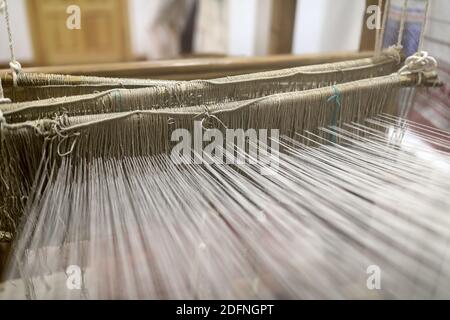View of vintage textile loom with wool threads Stock Photo