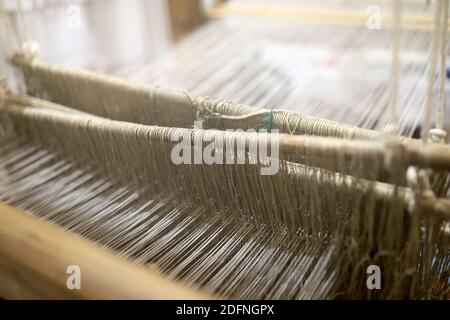 Details of vintage textile loom with wool threads Stock Photo