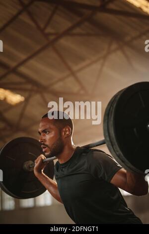 athletic man doing squat and back exercise and cross training with dumbbells  Stock Photo - Alamy