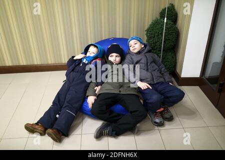 Children resting on bean bag chair indoor Stock Photo