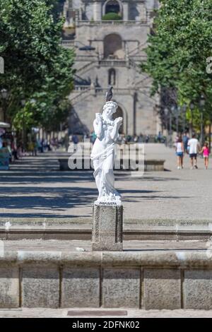 Lamego / Portugal - 07 25 2019 : View of the female statue representing spring, with dove over her head, square with people visiting as background Stock Photo