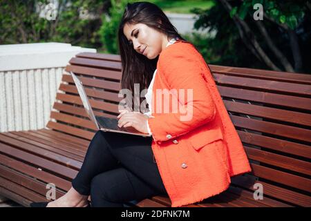 Beautiful fashion businesswoman with laptop work remotely Stock Photo