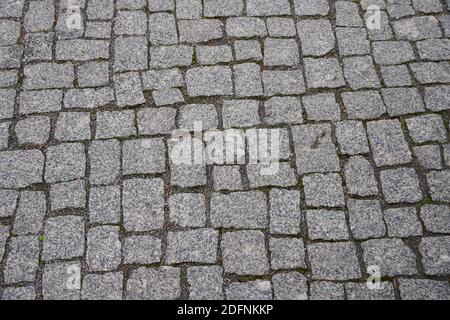 Old gray pavement in historical city centre