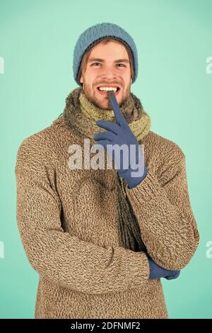 guy feel warm and comfortable. male knitwear fashion. men knitted cloth and accessory. male blue background. poor homeless man. funny man feeling cold in winter. no flu. winter weather forecast. Stock Photo