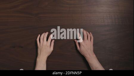 Top view man hands finger tap on black walnut table with copy space, wide photo Stock Photo