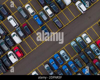 Top view of many parked cars waiting for shipping aerial drone view lined up structured Stock Photo