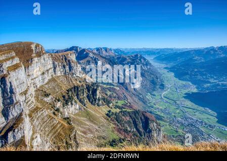 breathtaking view from zuestoll churfirsten into the valley and the small village of wallenstadt and mels. Autumn in Switzerland Stock Photo