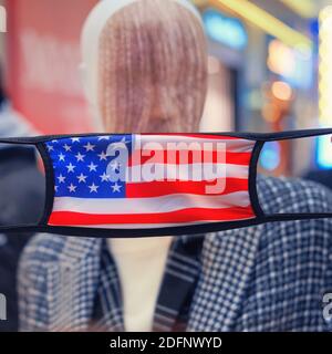 USA flag mask on mannequin face with fashionable clothes. Coronavirus care concept Stock Photo