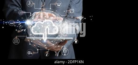 Businessman with tablet using Cloud computing. Futuristic display technology and connectivity concept. Mixed media Stock Photo