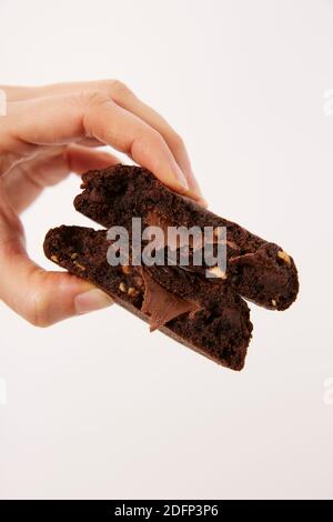 Hand holding chocolate cookies with liquid center Stock Photo