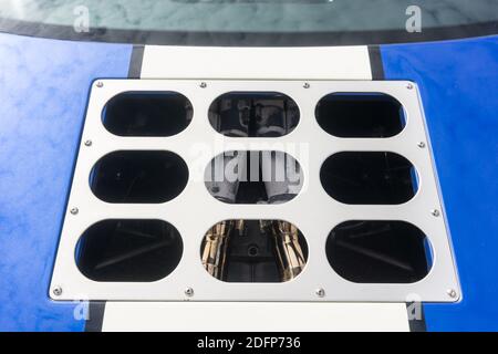 Close up detail of a vent over the exhaust manifold of a metallic blue and white Superformance GT40R high quality replica of the Ford GT40 Stock Photo