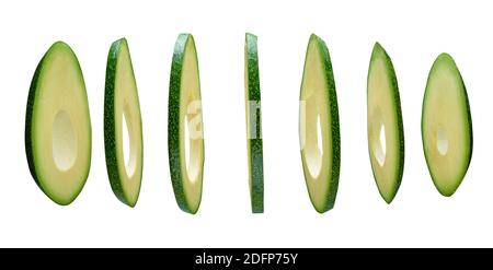 Avocado slices levitating in the air isolated on white background Stock Photo