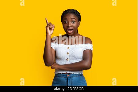 Great Idea. Excited Black Millennial Lady Pointing Finger Up Having Inspiration Stock Photo