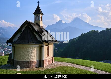 Small Kirchleitn chapel and alpine landscape with Watzmann mountain in the background in Berchtesgaden, Germany Stock Photo
