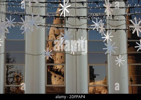 snowflakes shaped decorations hanging and the castle building reflecting over the windows in Budapest in winter time 2019 Stock Photo