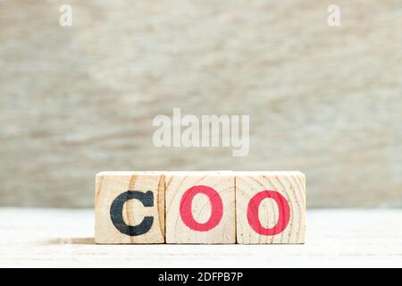 Alphabet letter block in word COO (abbreviation Chief operating officer) on wood background Stock Photo