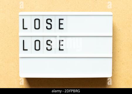 Lightbox with word lose lose on wood background Stock Photo