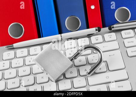 Open lock on PC keyboard with files and folders Stock Photo