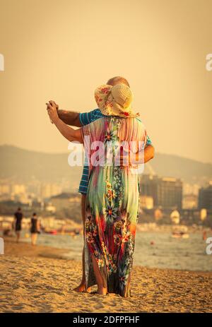 elderly couple takes a selfie on the beach Stock Photo