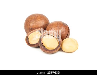 Split macadamia nuts with whole ones on a white background Stock Photo