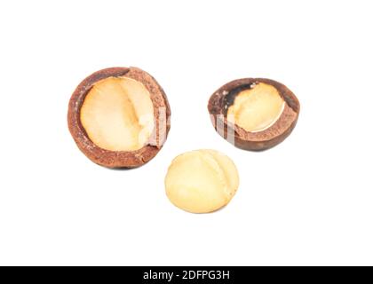 Split macadamia nuts with whole ones on a white background Stock Photo