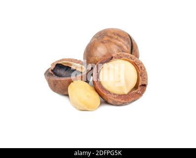 Split macadamia nuts with whole ones on a white background Stock Photo