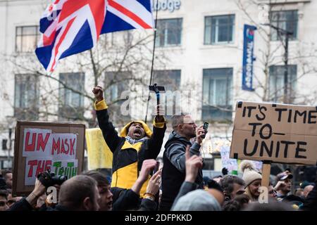 A protester chanting slogans while gesturing at Piccadilly Gardens during the freedom march.Protesters take to the streets again to rise awareness regarding the recent lockdowns and how it is affecting peoples livelihoods. Stock Photo