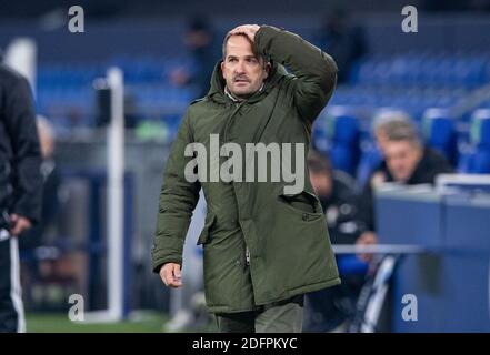 Gelsenkirchen, Germany. 06th Dec, 2020. Football: Bundesliga, FC Schalke 04 - Bayer Leverkusen, 10th matchday at the Veltins Arena. Schalke's coach Manuel Baum stands on the sidelines and grabs his head. Credit: Guido Kirchner/dpa - IMPORTANT NOTE: In accordance with the regulations of the DFL Deutsche Fußball Liga and the DFB Deutscher Fußball-Bund, it is prohibited to exploit or have exploited in the stadium and/or from the game taken photographs in the form of sequence images and/or video-like photo series./dpa/Alamy Live News Stock Photo