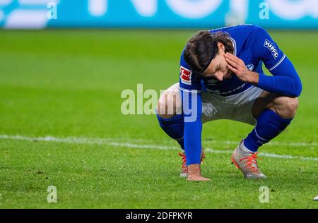 Gelsenkirchen, Germany. 06th Dec, 2020. Football: Bundesliga, FC Schalke 04 - Bayer Leverkusen, 10th matchday at the Veltins Arena. Schalke's Benjamin Stambouli squats in the penalty area and grabs his head. Credit: Guido Kirchner/dpa - IMPORTANT NOTE: In accordance with the regulations of the DFL Deutsche Fußball Liga and the DFB Deutscher Fußball-Bund, it is prohibited to exploit or have exploited in the stadium and/or from the game taken photographs in the form of sequence images and/or video-like photo series./dpa/Alamy Live News Stock Photo