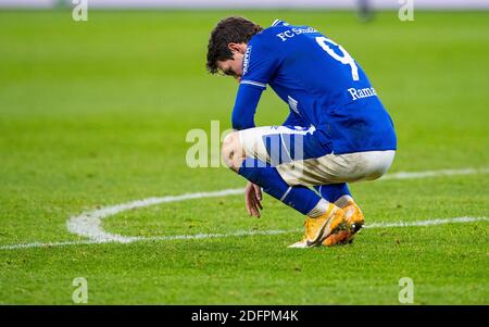 Gelsenkirchen, Germany. 06th Dec, 2020. Football: Bundesliga, FC Schalke 04 - Bayer Leverkusen, 10th matchday at the Veltins Arena. Schalke's Benito Raman squats on the grass after the final whistle. Credit: Guido Kirchner/dpa - IMPORTANT NOTE: In accordance with the regulations of the DFL Deutsche Fußball Liga and the DFB Deutscher Fußball-Bund, it is prohibited to exploit or have exploited in the stadium and/or from the game taken photographs in the form of sequence images and/or video-like photo series./dpa/Alamy Live News Stock Photo