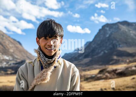 (201206) -- CHENGDU, Dec. 6, 2020 (Xinhua) -- Tamdrin is pictured on his way home from Litang County, the Tibetan Autonomous Prefecture of Garze, southwest China's Sichuan Province, Dec. 2, 2020. Tamdrin, whose Mandarin name is Ding Zhen, is a 20-year-old Tibetan herder from a village of Litang County in the Tibetan Autonomous Prefecture of Garze in Sichuan Province. Less than a month ago, he was still an ordinary herder, until a 7-second video featuring a smiling Tamdrin went viral, making him the latest social media sensation in China. What makes Tamdrin stand out from other internet ce Stock Photo