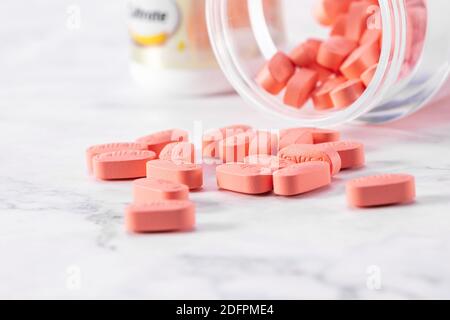 pink medical pills of Caltrate with a transparent bottle isolated on a ...