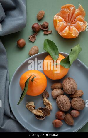 Easy peelers and mixed nuts from above Stock Photo