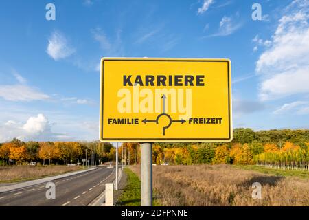 A yellow sign with directions showing to career, family or free time - choice concept Stock Photo