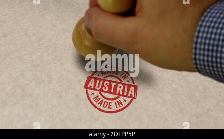 Made in Austria stamp and stamping hand. Factory, manufacturing and production country concept. Stock Photo