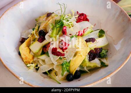 vegetable salad bowl with asparagus, fennel, avocado, raisins and mix lettuce Stock Photo