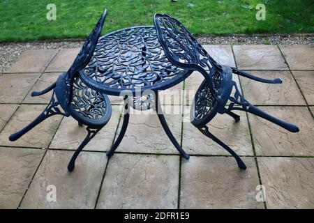 7 November 2020 - London, UK: Two garden chairs resting on matching table Stock Photo
