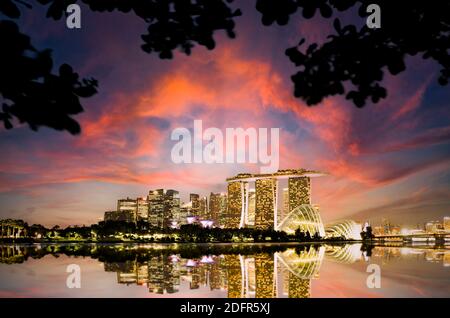 Stunning view of the Singapore's skyline during a beautiful and dramatic sunset.  Singapore is a sovereign island city-state in Southeast Asia. Stock Photo