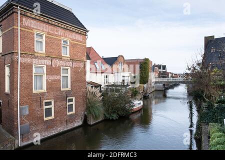 Damsterdiep with historic buildings and bridge  in Appingedam, Groningen, the Netherlands Stock Photo