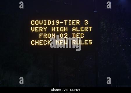 n electronic variable message traffic sign showing coronavirus informationon tier 3 Stock Photo