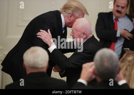 WASHINGTON, DC - OCTOBER 25: (AFP OUT ) U.S. President Donald Trump shakes hands with former Commandant of the Marine Corps retired Gen. Alfred Gray while commemorating the 35th anniversary of attack on the Beirut Barracks in the East Room of the White House October 25, 2018 in Washington, DC. On October 23, 1983 two truck bombs struck the buildings housing Multinational Force in Lebanon (MNF) peacekeepers, killing 241 U.S. and 58 French peacekeepers and 6 civilians. Photo by Chip Somodevilla/ABACAPRESS.COM Stock Photo