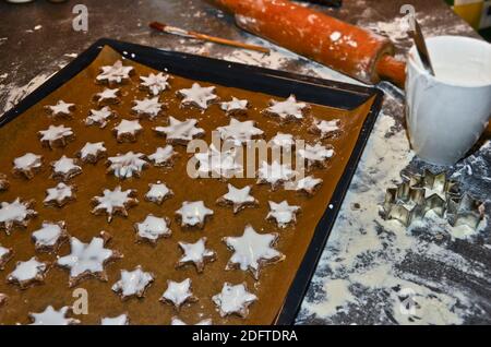 cinnamon stars, cookies flat layed on a baking sheet, ready to be baked for Christmas Stock Photo