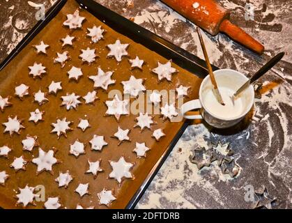 cinnamon stars, cookies flat layed on a baking sheet, ready to be baked for Christmas Stock Photo