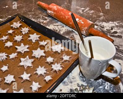 cinnamon stars, cookies flat layed on a baking sheet, ready to be baked for Christmas Stock Photo