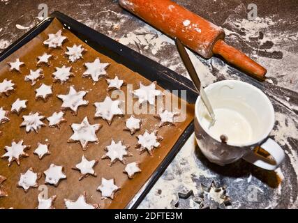 cinnamon stars, cookies flat layed on a baking sheet, ready to be baked for Christmas Stock Photo