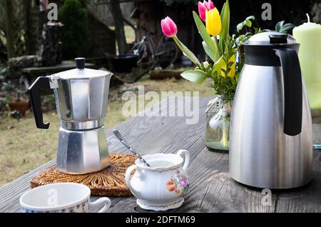 https://l450v.alamy.com/450v/2dftm69/coffee-maker-in-still-life-with-on-wooden-table-with-flowers-in-spring-time-2dftm69.jpg